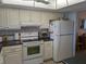 White cabinets, dark countertops, and full-size appliances at 3935 Lake Bayshore Dr # F-316, Bradenton, FL 34205