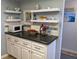 White cabinets and dark countertops with microwave at 3935 Lake Bayshore Dr # F-316, Bradenton, FL 34205