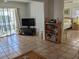 Living room with tiled floors and views into the bedroom and balcony at 3935 Lake Bayshore Dr # F-316, Bradenton, FL 34205