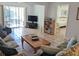 Bright living room with tiled floors, comfy furniture, and access to a balcony at 3935 Lake Bayshore Dr # F-316, Bradenton, FL 34205