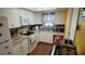 Galley kitchen with white cabinets and modern appliances at 4924 Live Oak Cir # 115, Bradenton, FL 34207