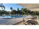 Refreshing community pool with lounge chairs and patio tables at 4924 Live Oak Cir # 115, Bradenton, FL 34207