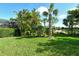 Beautifully landscaped yard with tropical plants and lush grass at 5325 Sundew Dr, Sarasota, FL 34238