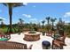 Round fire pit with wooden chairs and landscaping at 5325 Sundew Dr, Sarasota, FL 34238