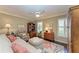 Relaxing sitting room with comfortable seating and coral rug at 5663 Country Lakes Dr, Sarasota, FL 34243