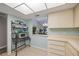 Kitchen features white cabinets, microwave, and view to living room at 6515 Heritage Ln # 2615, Bradenton, FL 34209