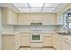 Efficient kitchen with white cabinets, appliances, and tile floors at 6515 Heritage Ln # 2615, Bradenton, FL 34209