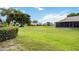 Landscaped backyard with lush green grass and homes at 6515 Heritage Ln # 2615, Bradenton, FL 34209