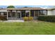 Rear view of home with screened patio and lawn at 6515 Heritage Ln # 2615, Bradenton, FL 34209