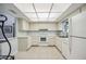 Kitchen with white cabinets, tiled floor, and appliances at 6515 Heritage Ln # 2615, Bradenton, FL 34209