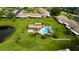Community pool, spa, and clubhouse with lush landscaping at 6515 Heritage Ln # 2615, Bradenton, FL 34209