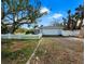 Home with white garage door and fence at 6901 Poinsettia Ave, Longboat Key, FL 34228