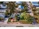 Coastal cottage with mature trees and a fenced yard at 6901 Poinsettia Ave, Longboat Key, FL 34228