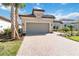 One-story house with a two-car garage and a brick driveway at 10128 Morning Mist Ln, Sarasota, FL 34241
