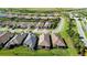 Aerial view of the back of several homes with tile roofs at 10128 Morning Mist Ln, Sarasota, FL 34241