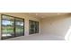 Spacious covered patio with glass sliding doors and access to backyard at 10128 Morning Mist Ln, Sarasota, FL 34241