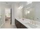 Spacious bathroom features a double sink vanity, marble counters, and view to the main bedroom at 10128 Morning Mist Ln, Sarasota, FL 34241