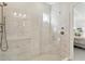 Marble tiled walk-in shower featuring a built-in bench and handheld shower head at 10128 Morning Mist Ln, Sarasota, FL 34241