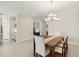 Dining room view showcasing table, chairs, chandelier, and an open floor plan with kitchen view at 10128 Morning Mist Ln, Sarasota, FL 34241