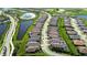 Aerial view of a community with houses and ponds at 10128 Morning Mist Ln, Sarasota, FL 34241
