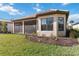 House with screened lanai, landscaping and grassy backyard at 10128 Morning Mist Ln, Sarasota, FL 34241