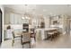 Open kitchen featuring a large island with seating, stainless steel appliances, and a breakfast nook at 10128 Morning Mist Ln, Sarasota, FL 34241