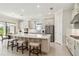 Spacious kitchen features a large island with seating, stainless steel appliances, and a neutral color scheme at 10128 Morning Mist Ln, Sarasota, FL 34241