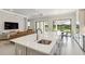 Open concept kitchen showcasing a center island, stainless steel appliances, and seamless flow to the living area at 10128 Morning Mist Ln, Sarasota, FL 34241