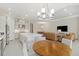 Open kitchen with stainless steel appliances, large island, and adjacent dining and living spaces at 10128 Morning Mist Ln, Sarasota, FL 34241