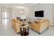 Living room showcases an area rug, modern furnishings, and is open to a dining room with light, neutral walls and flooring at 10128 Morning Mist Ln, Sarasota, FL 34241