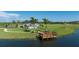 Relaxing lakeside pavilion with seating and grilling area at 10128 Morning Mist Ln, Sarasota, FL 34241