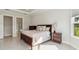 Bright main bedroom features trey ceiling, king bed, and view to ensuite bathroom at 10128 Morning Mist Ln, Sarasota, FL 34241