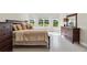 Comfortable main bedroom with bay window and view to backyard. Features a king bed and nice furnishings at 10128 Morning Mist Ln, Sarasota, FL 34241