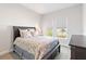 Bedroom with dark-brown sleigh bed and neutral decor at 10128 Morning Mist Ln, Sarasota, FL 34241