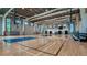 Indoor basketball court with seating and two hoops at 10128 Morning Mist Ln, Sarasota, FL 34241