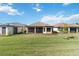 Home with screened patio, lush landscaping and grassy backyard at 10128 Morning Mist Ln, Sarasota, FL 34241