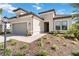 One-story home with a two-car garage and landscaping at 10128 Morning Mist Ln, Sarasota, FL 34241