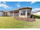 Home with screened lanai, landscaping and grassy backyard at 10128 Morning Mist Ln, Sarasota, FL 34241