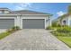 Two-car garage with paver driveway at 12797 Palatka Dr, Venice, FL 34293