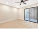 Spacious bedroom featuring light walls, wood-look flooring, and sliding glass doors at 1305 Water Oak N Way, Bradenton, FL 34209