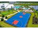 Full-size outdoor basketball court with red and blue paint at 15221 Lyla Ter, Lakewood Ranch, FL 34211