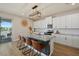 Modern kitchen with white cabinets, granite countertops and island with seating at 17015 Harvest Moon Way, Bradenton, FL 34211