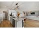 Modern kitchen features white cabinets, granite island, and stainless steel appliances at 17015 Harvest Moon Way, Bradenton, FL 34211