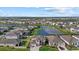 Aerial view showcasing a house near a lake in a residential area at 17015 Harvest Moon Way, Bradenton, FL 34211