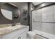 Contemporary bathroom with walk-in shower and granite vanity at 17015 Harvest Moon Way, Bradenton, FL 34211