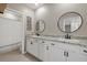 Double vanity bathroom with granite countertop and black fixtures at 17015 Harvest Moon Way, Bradenton, FL 34211
