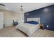 Main bedroom with a king-size bed and a navy blue accent wall at 17015 Harvest Moon Way, Bradenton, FL 34211