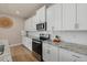 Modern kitchen with white cabinets, granite countertops and stainless steel appliances at 17015 Harvest Moon Way, Bradenton, FL 34211