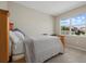 Cozy bedroom with wood frame bed and view of backyard at 17015 Harvest Moon Way, Bradenton, FL 34211