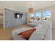 Open living area with stone feature wall, comfortable sectional sofa and large windows at 17015 Harvest Moon Way, Bradenton, FL 34211
